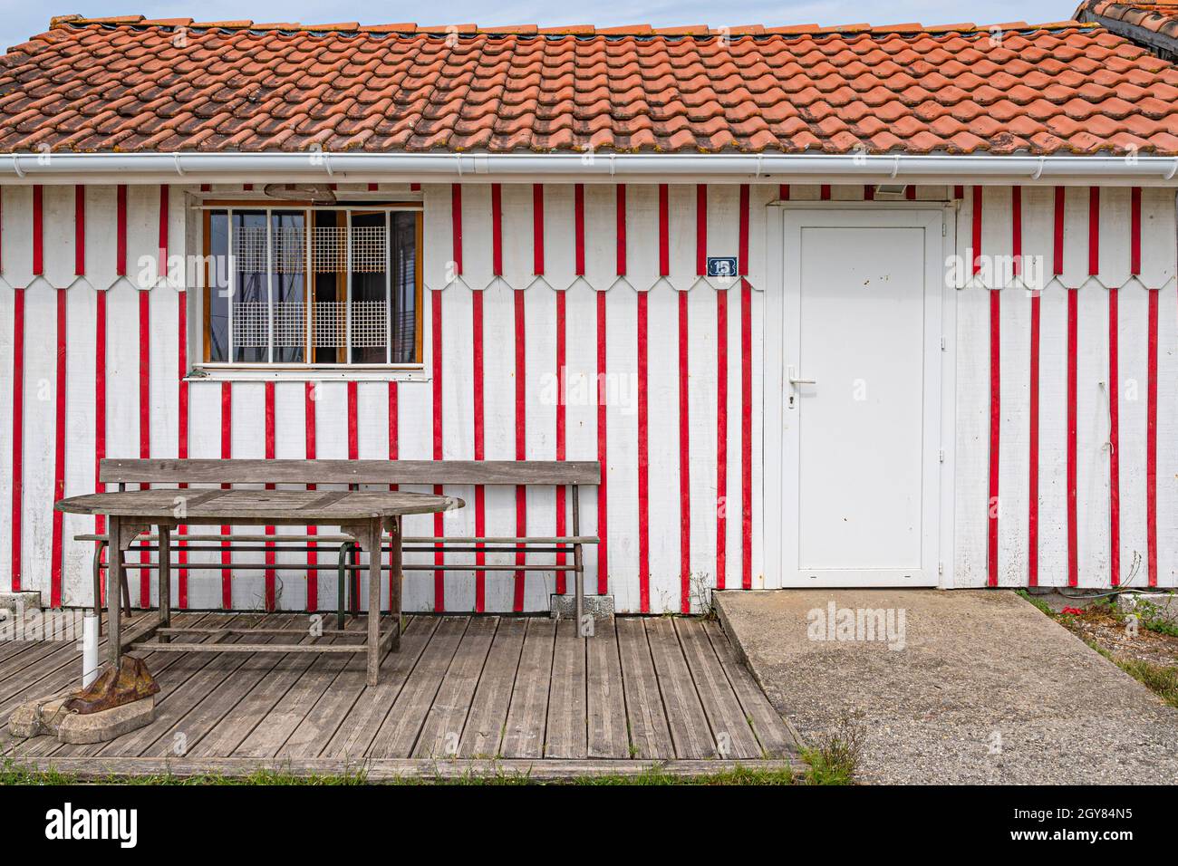 The huts of the oyster fisher are all colourful decorated in stripes and border the small port of Audenge, bassin d'Arcachon, France Stock Photo