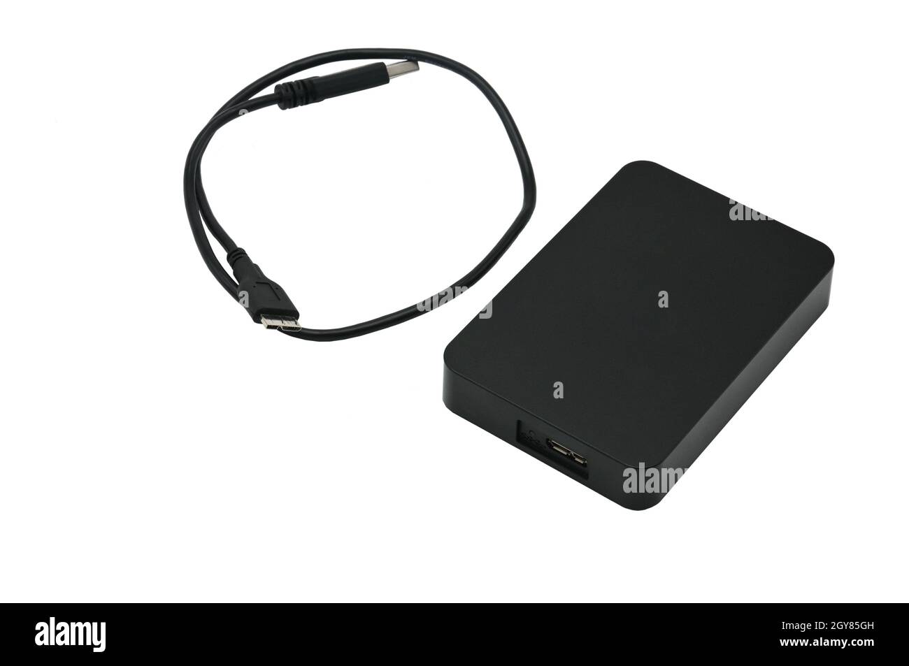 Portable hard drive for backing up various files on an isolated white background Stock Photo