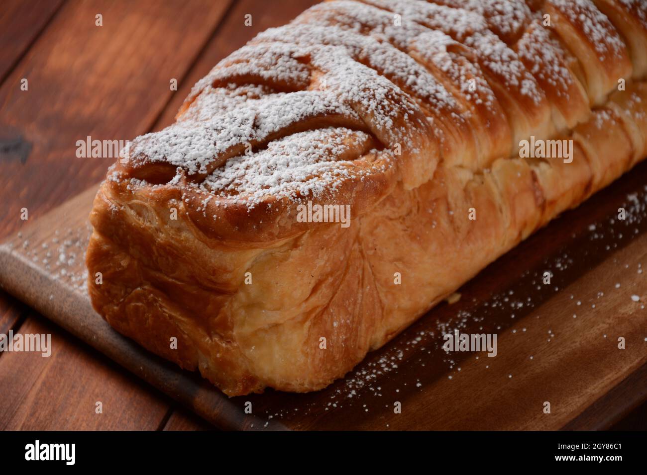 Austrian strudel with mint and with powdered sugar on a plate. Cake with apple jam Stock Photo