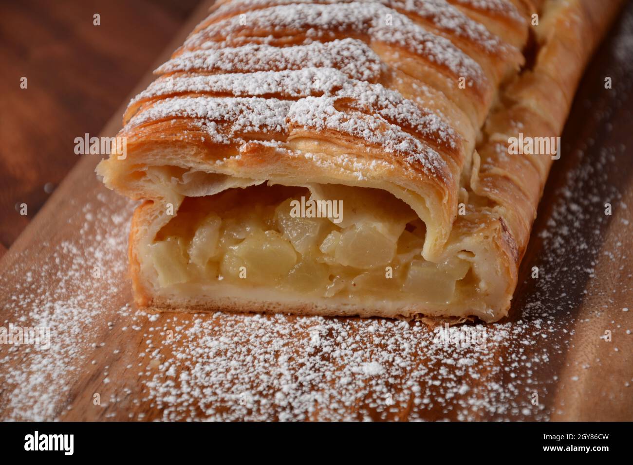 Austrian strudel with mint and with powdered sugar on a plate. Cake with apple jam Stock Photo