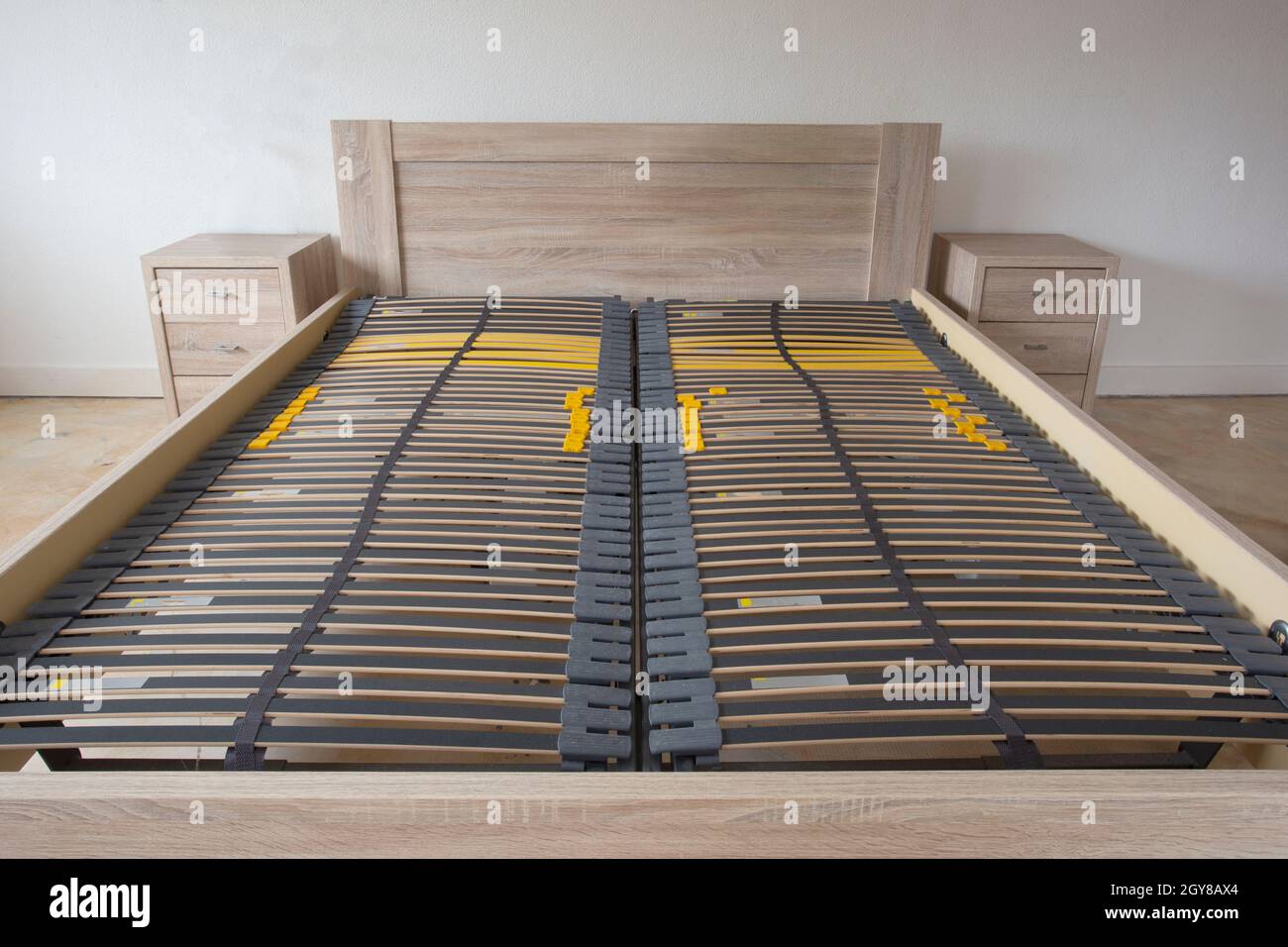 Slatted base, wooden element double bed frame close up in bedroom