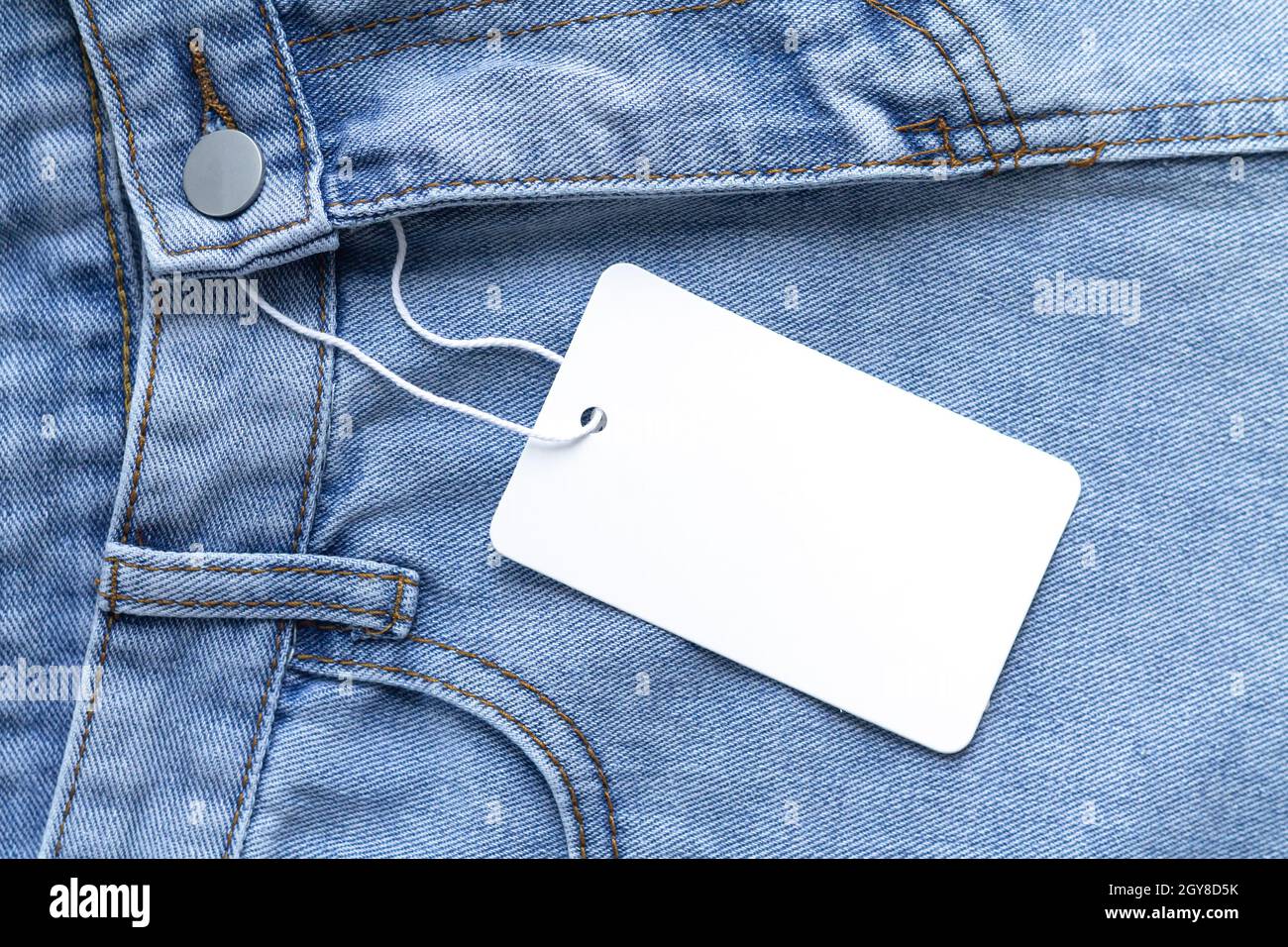Blank white card on jeans background template Stock Photo - Alamy