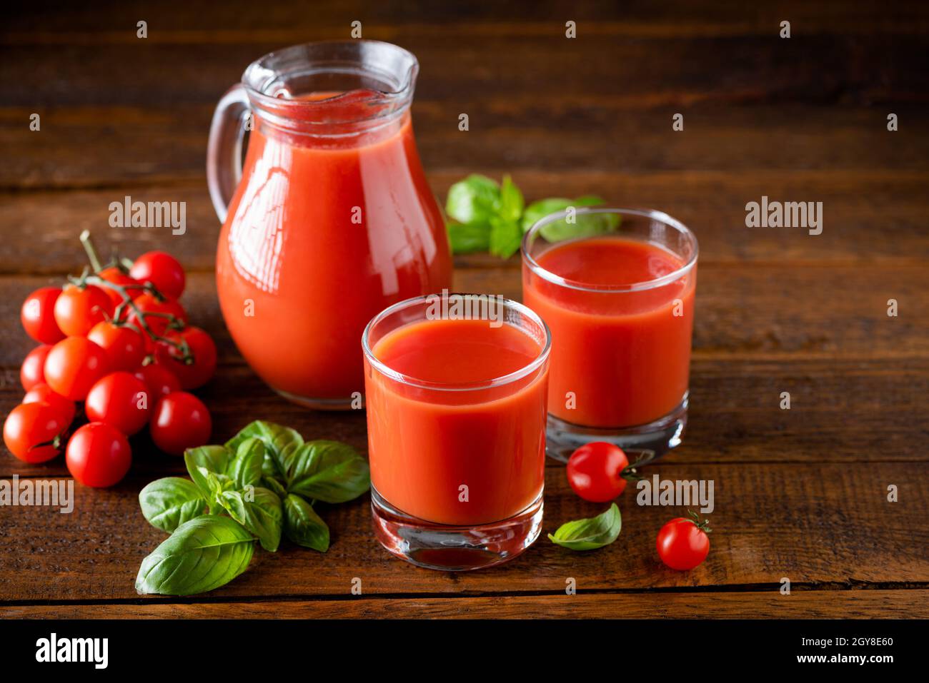 Tomato juice in glass on a wooden table background. Natural organic tomato juice Stock Photo