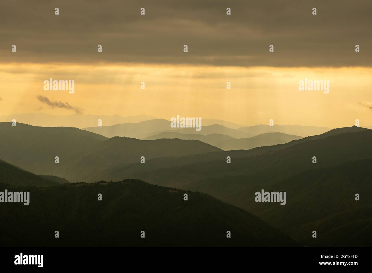 Morning sunlight in spring mountains. Beautiful sun rays on background. Landscape photography Stock Photo