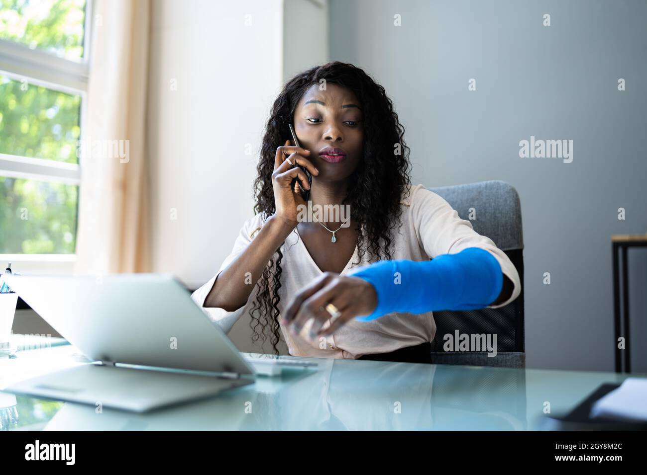 Broken Arm Injured Worker Compensation Coverage. Using Office Laptop Stock Photo