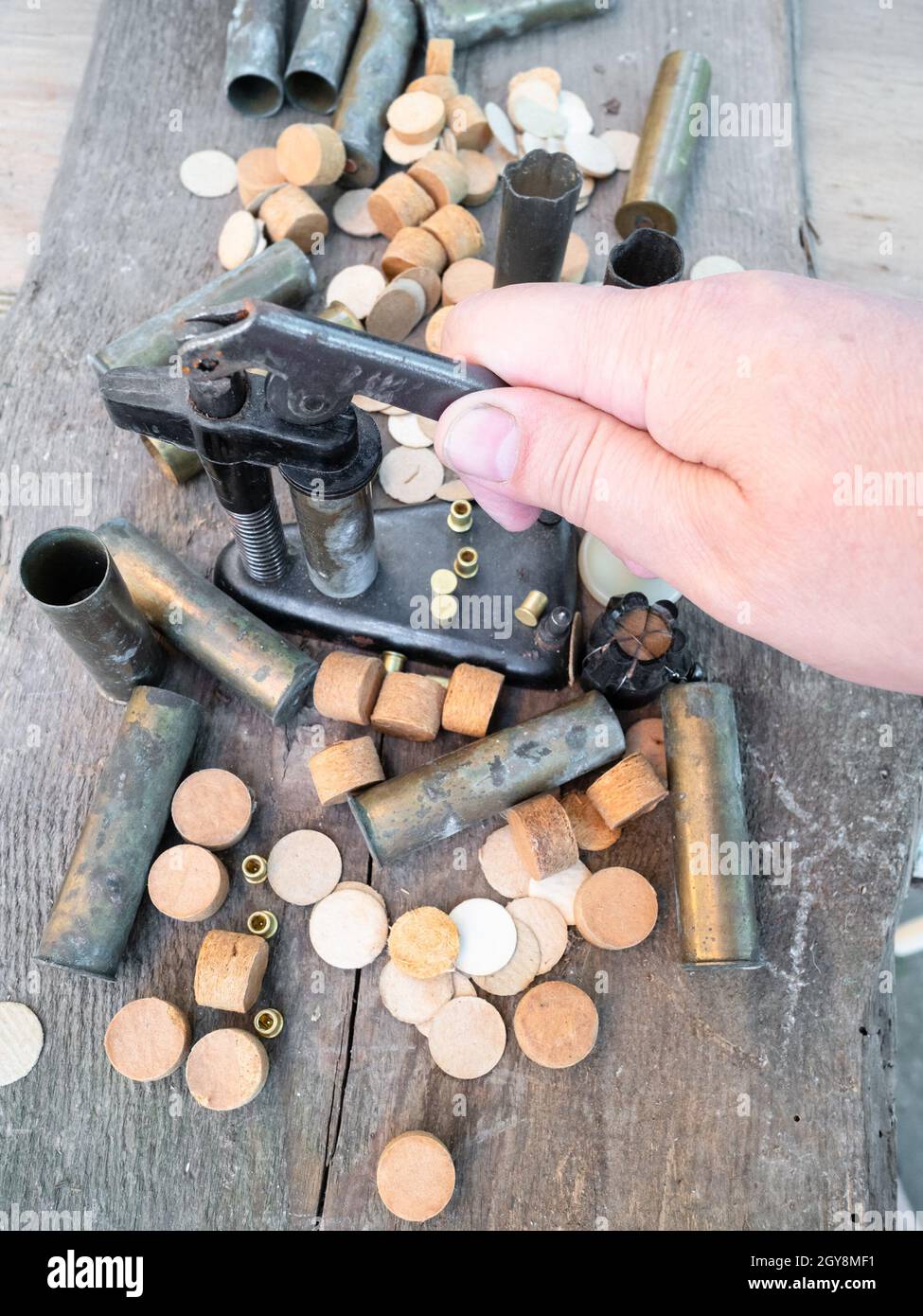 hand presses reloading press with cartridge case closeup on plank Stock Photo