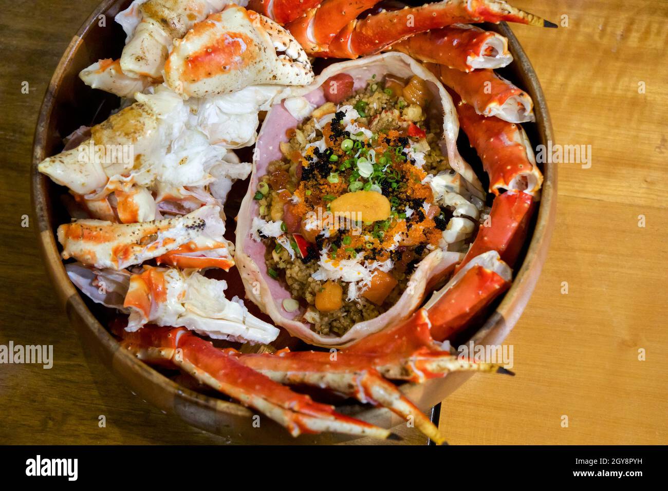 Live TARABA King Crab steamed on wooden tray. Legs and claws were cut ...