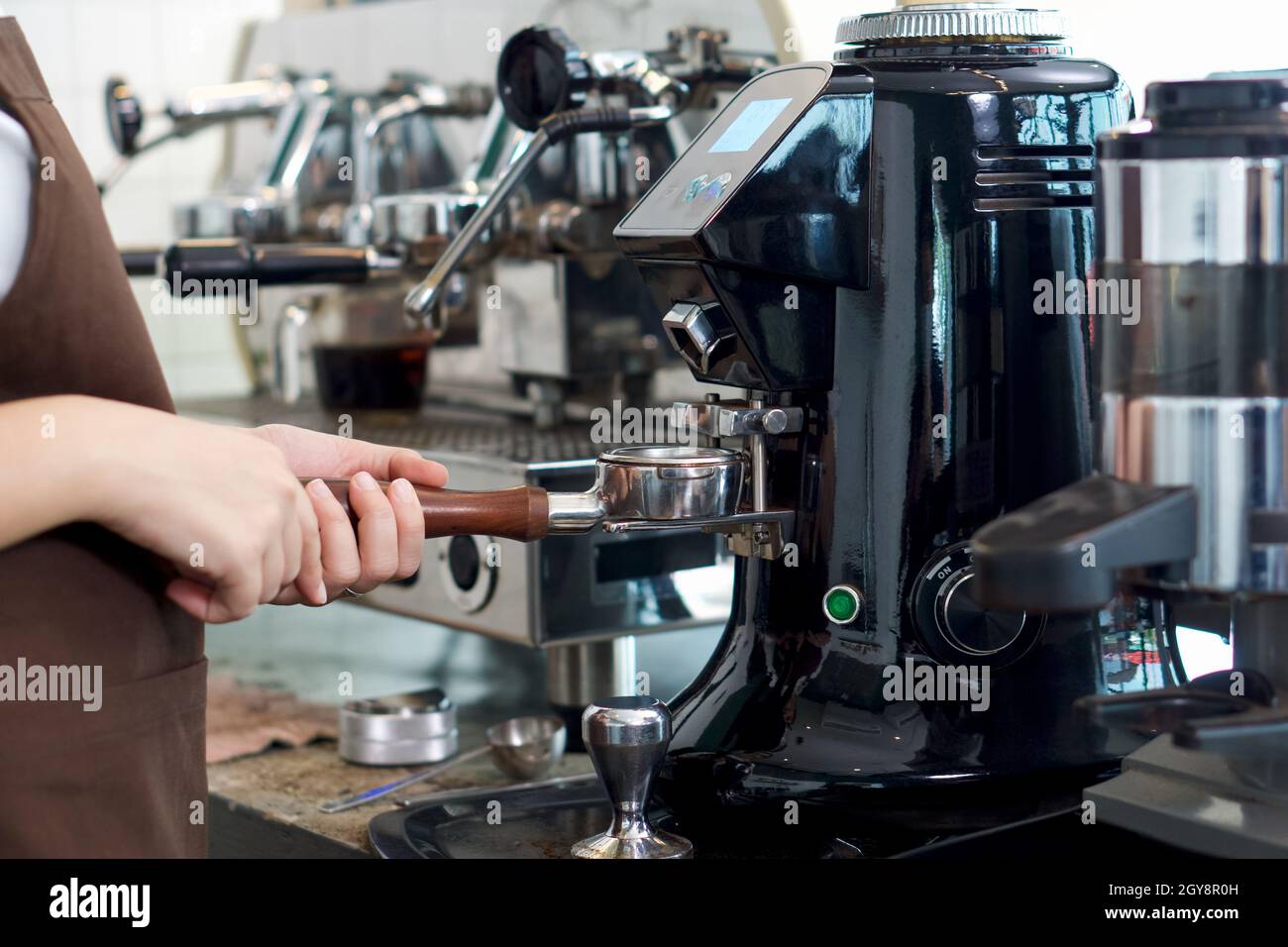 Barista making fresh espresso coffee. Espresso Machine Portafilters