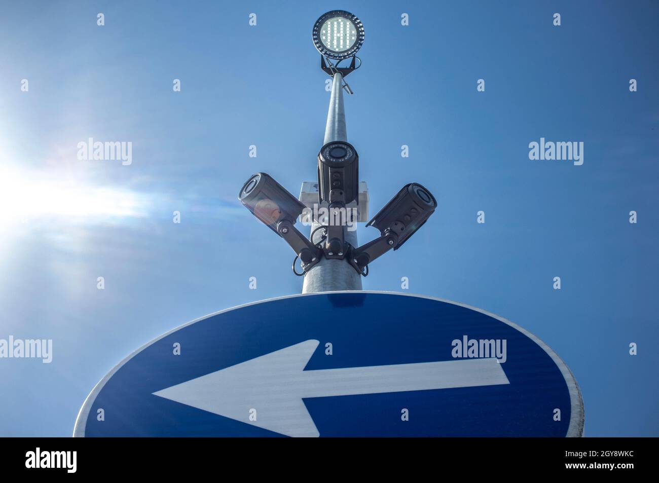 Three surveillance cameras attached on traffic signal pole with led ...