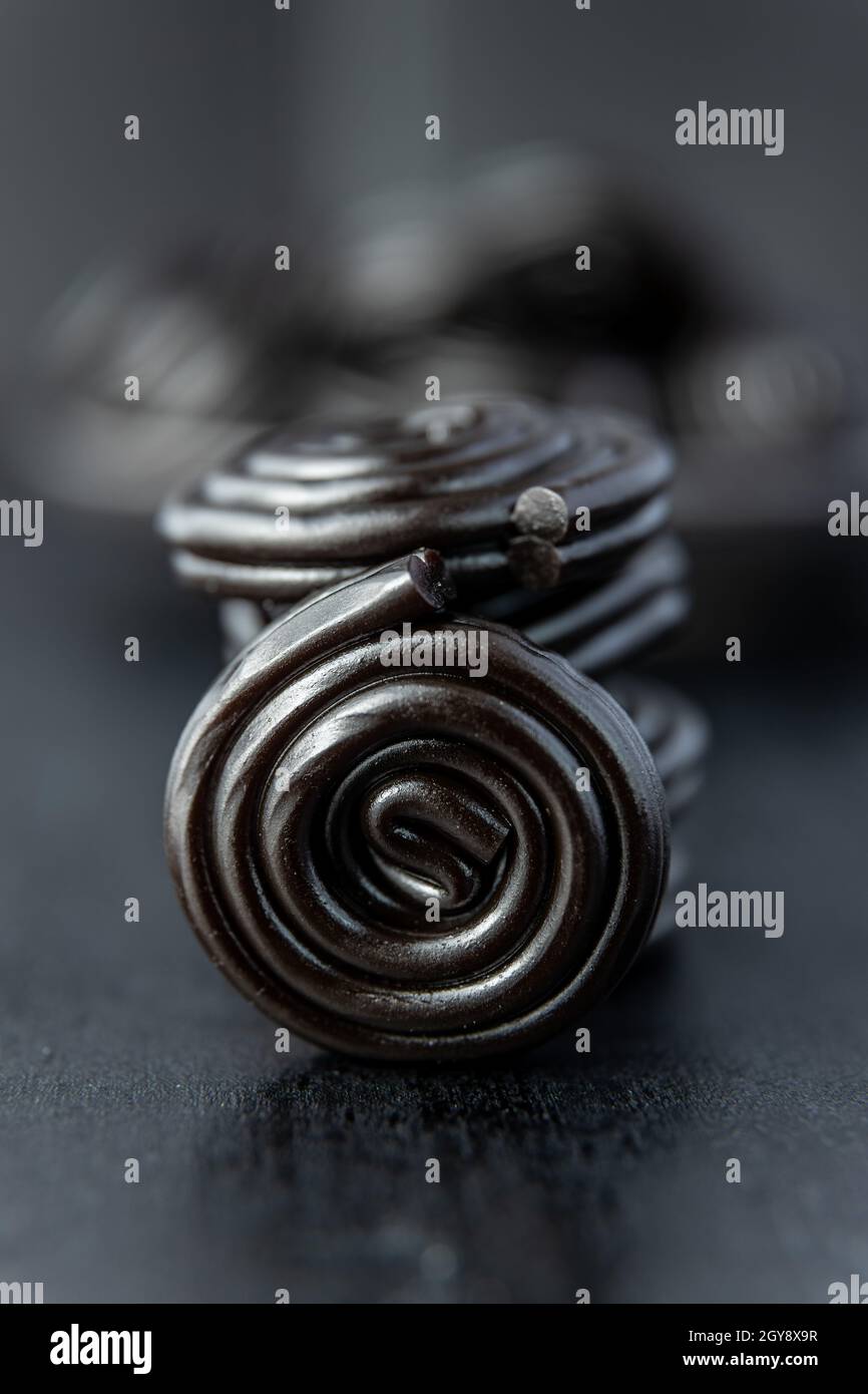 Spiral from liquorice candy on black table. Stock Photo