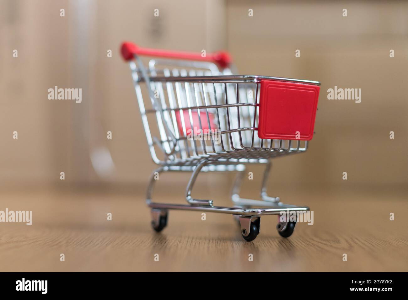 Online-Shopping and parcel service concept: Miniature shopping cart and ...