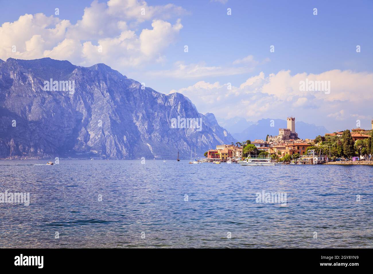 Idyllic italian coastline with water, a cute little village, mountains and the sky Stock Photo