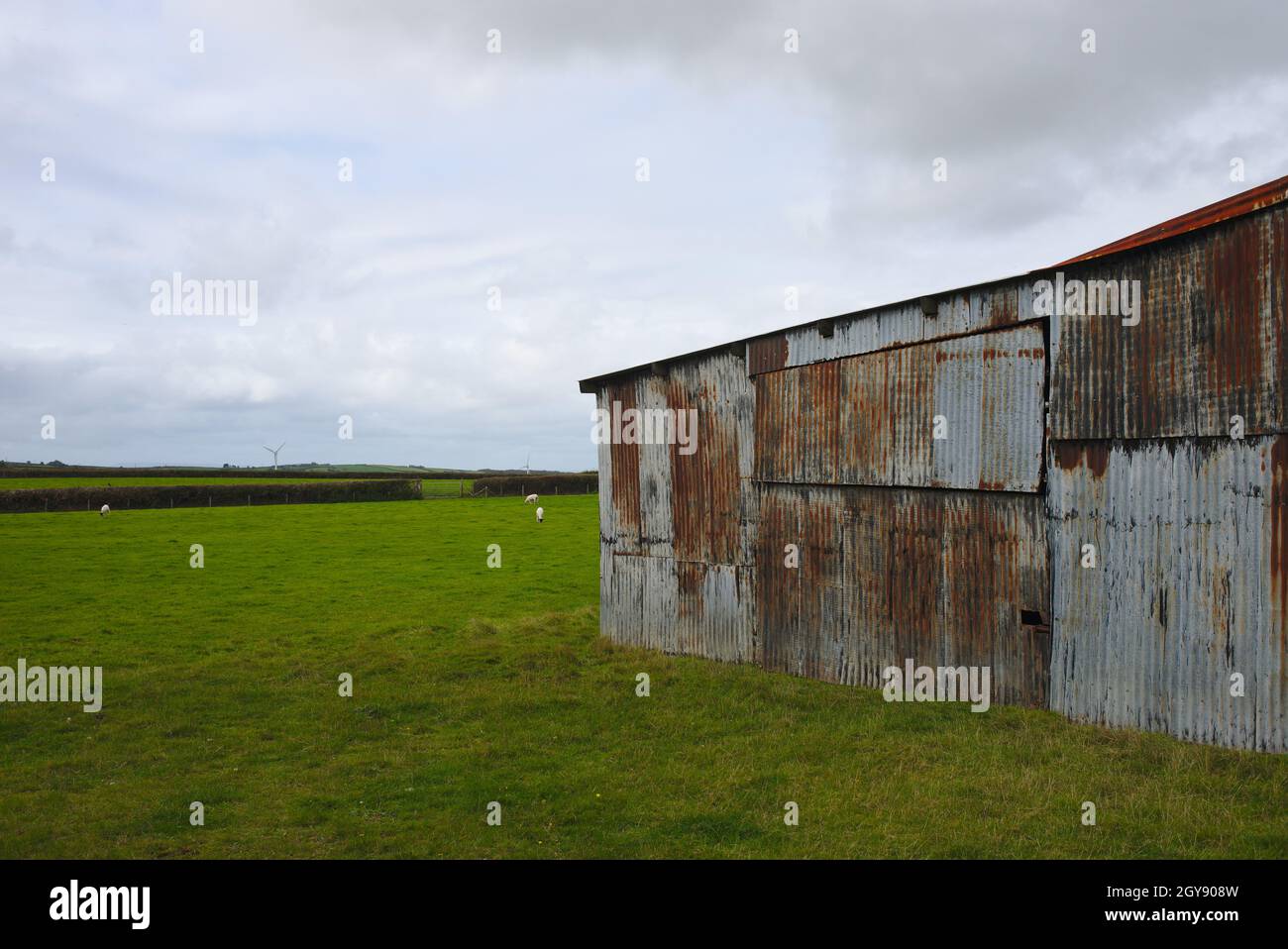 Farm building barn clad with old corrugated iron sheets Stock Photo