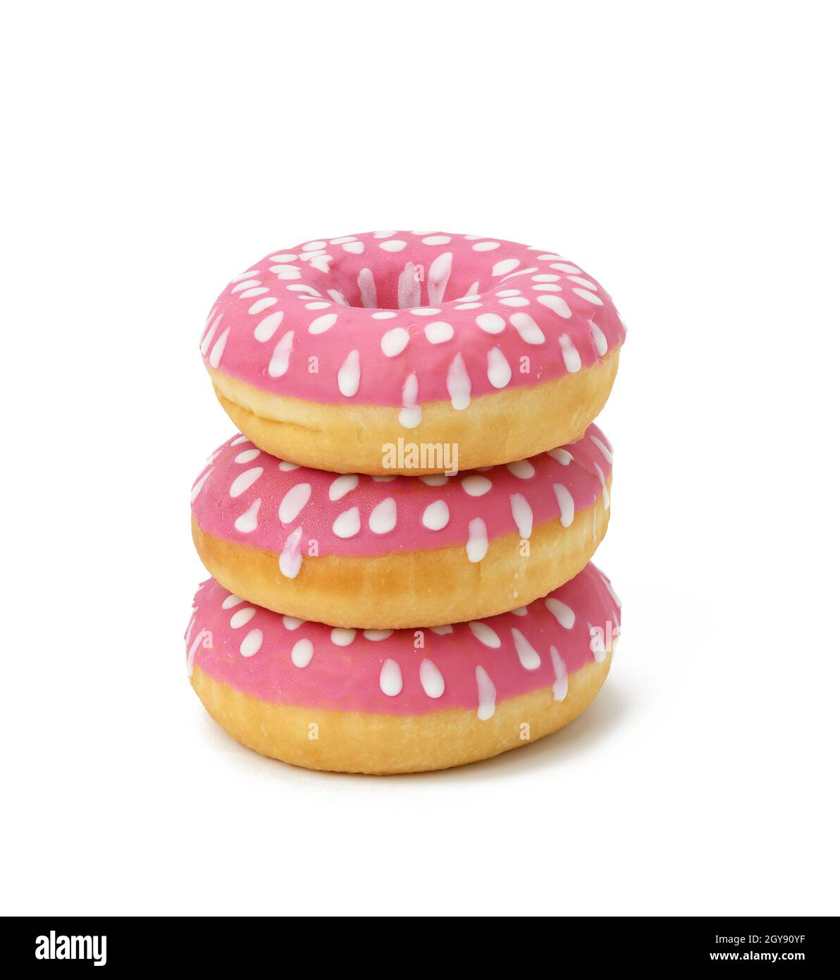 baked round donut with pink icing and white dots isolated on white background, stack Stock Photo