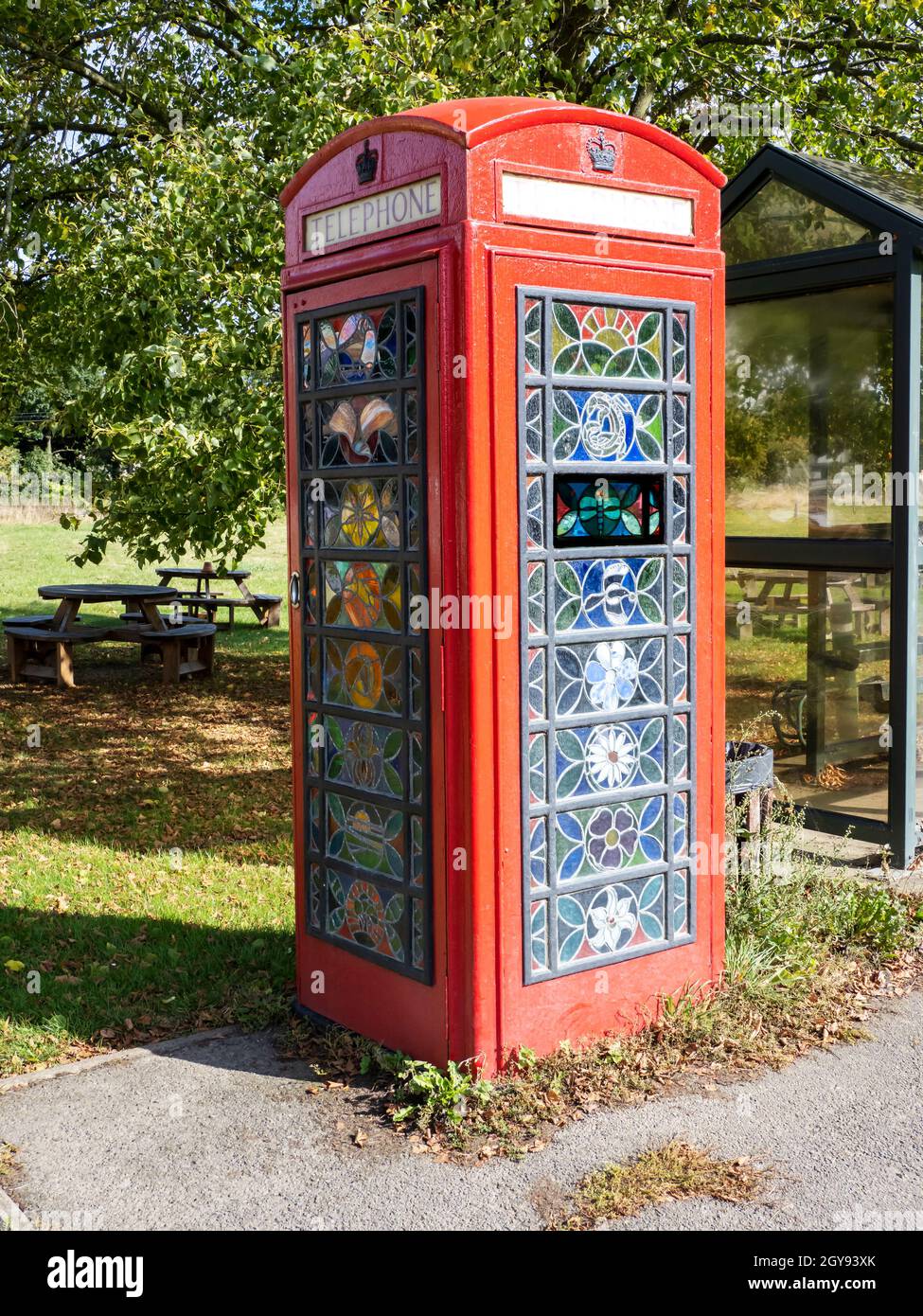 An old phone box with stained glass windows in Mellis, Suffolk, UK