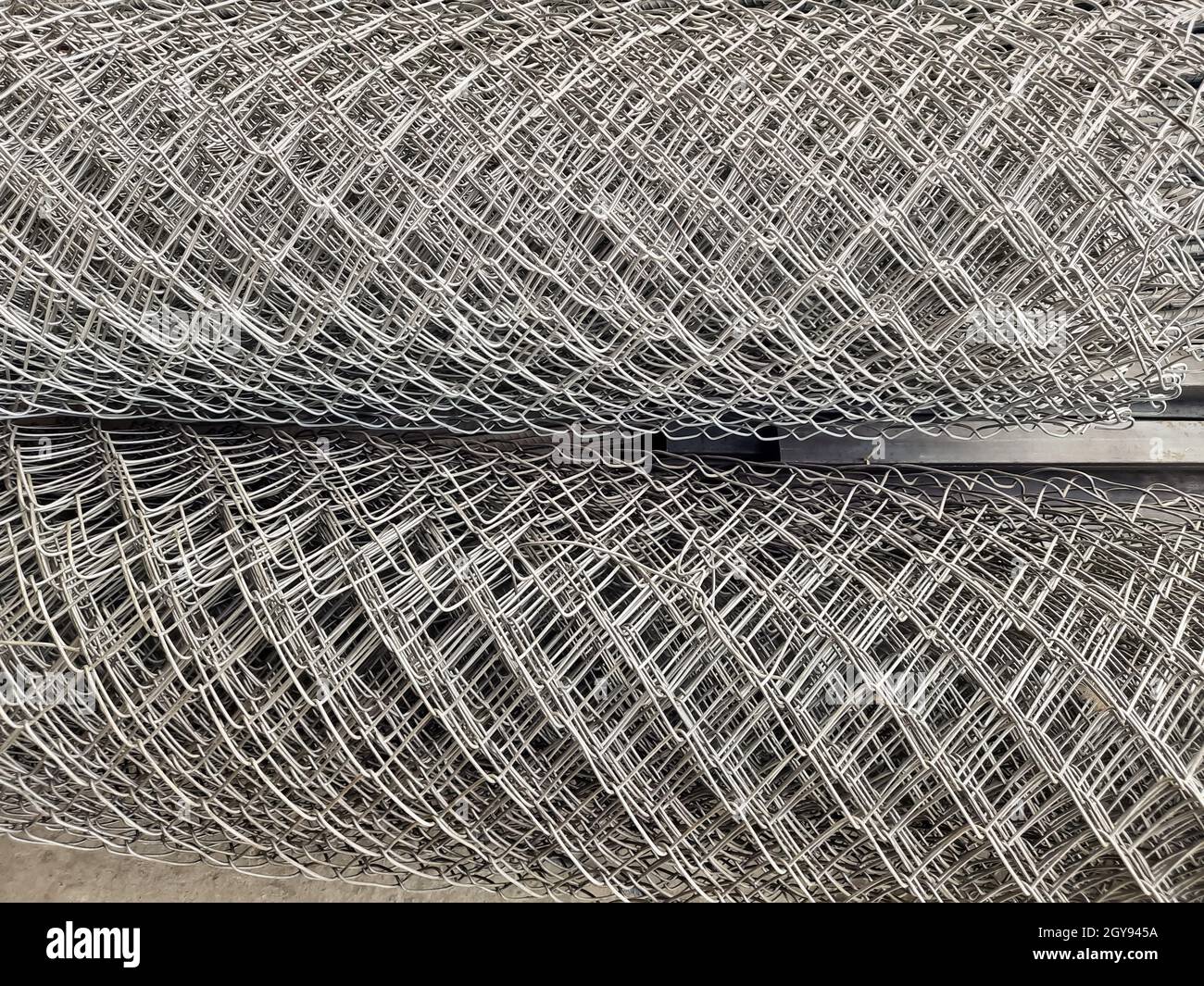 Metal bars background in diagonal lines close-up, industrial mesh of steel wire texture, building material Stock Photo
