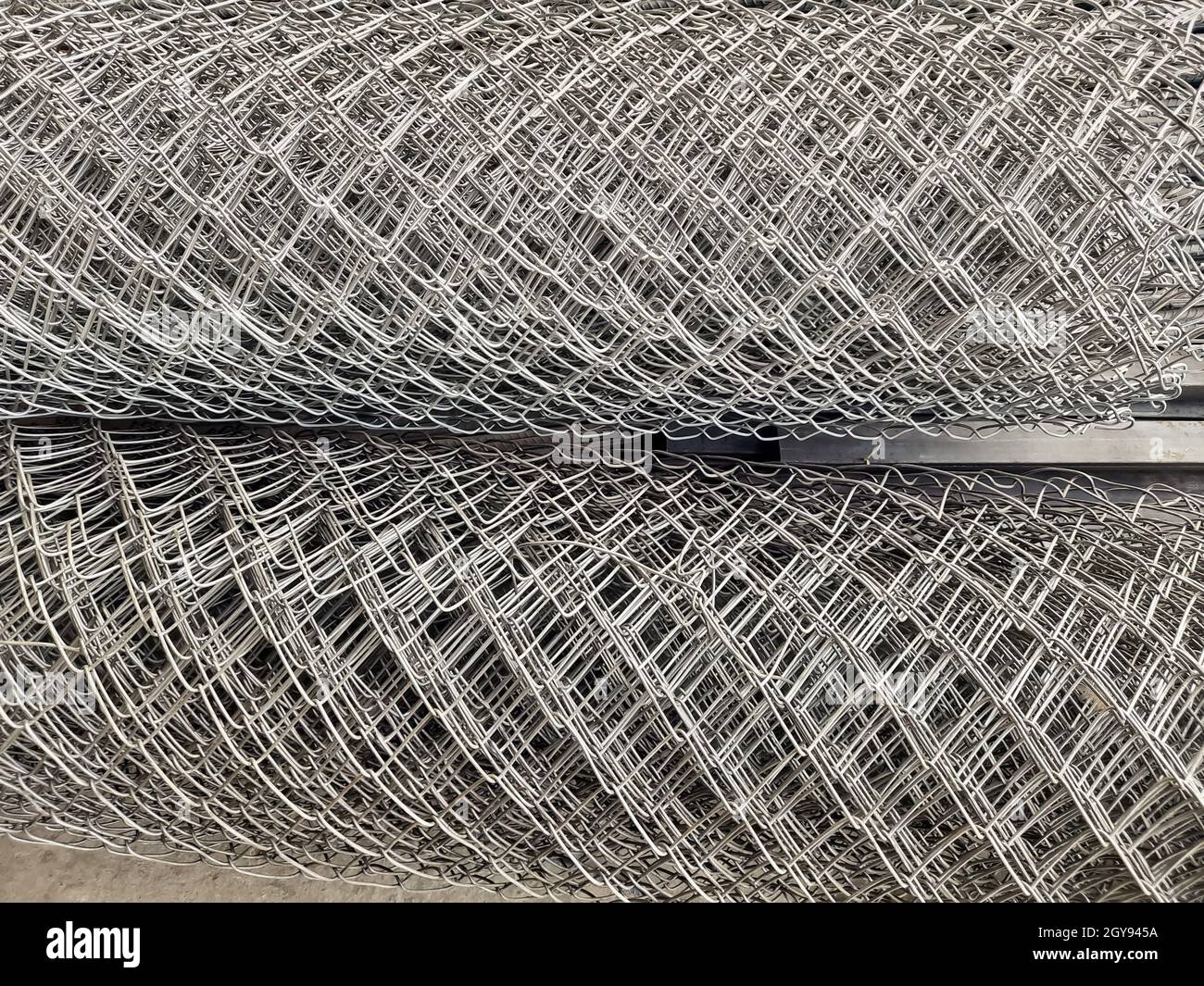 Metal bars background in diagonal lines closeup, industrial mesh of