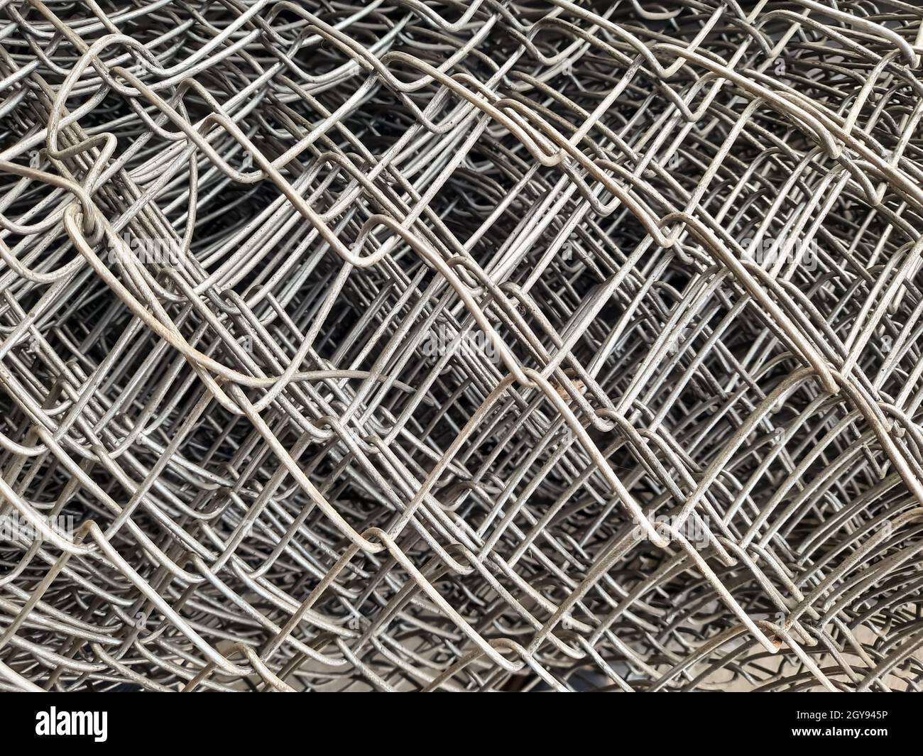 close up rolls of iron mesh (wire mesh) in construction site. metal steel reinforced rod for concrete. building construction and industry concept - im Stock Photo