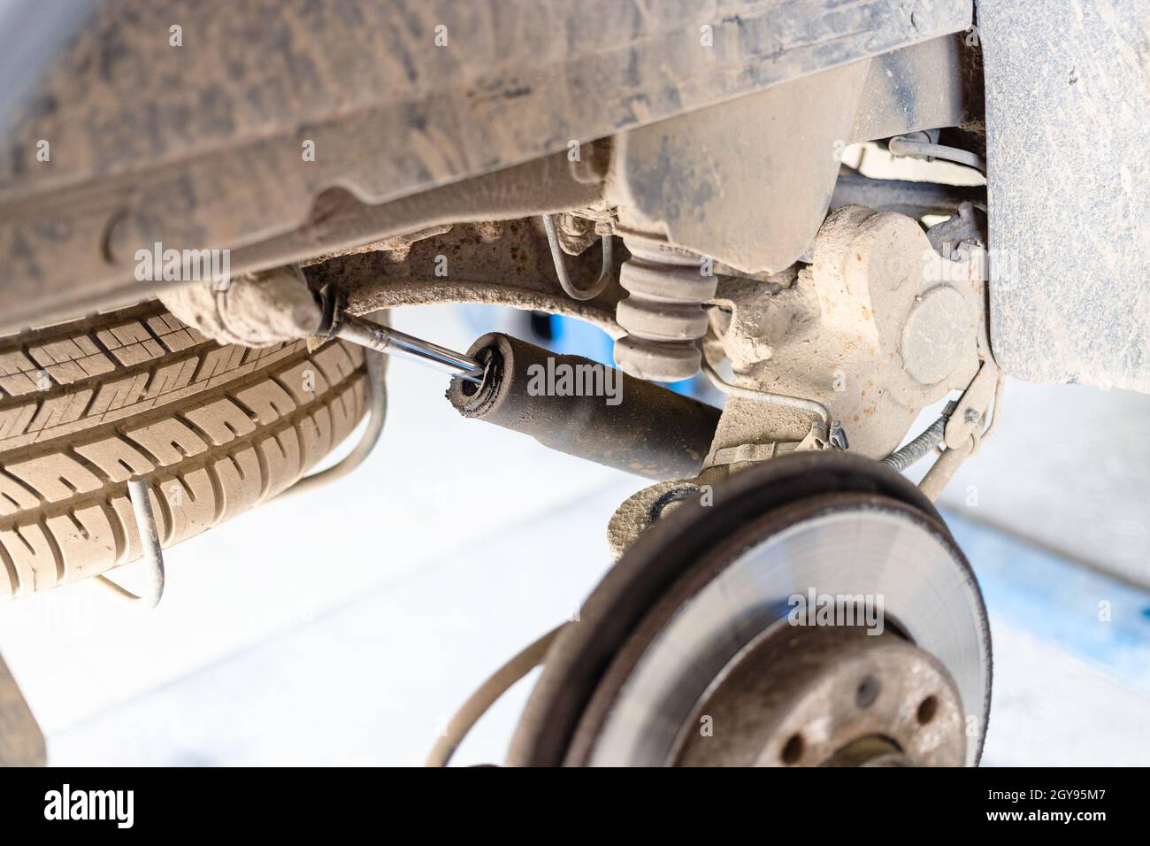 broken rear shock absorber on old car (focus on car shock absorber rod) Stock Photo