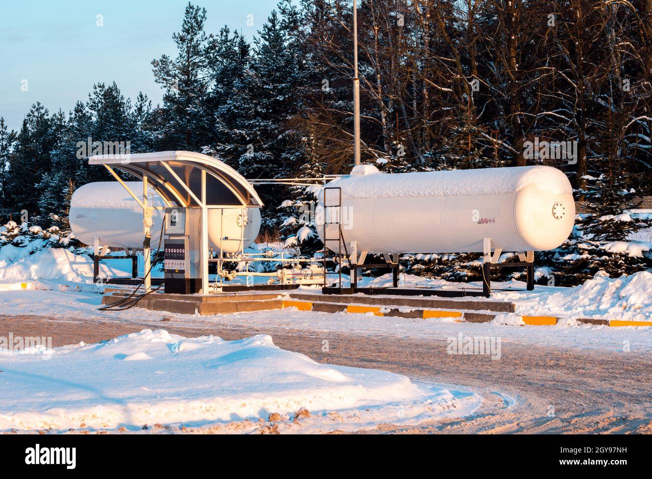 Fuel tank of liquid propane gas station. Fuel tank of LPG station under snow. Winter view of LPG station for filling liquefied gas into the vehicle. E Stock Photo