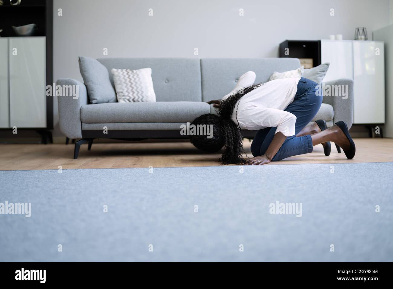 African Woman Lost Key Or Phone. Searching For Something Stock Photo