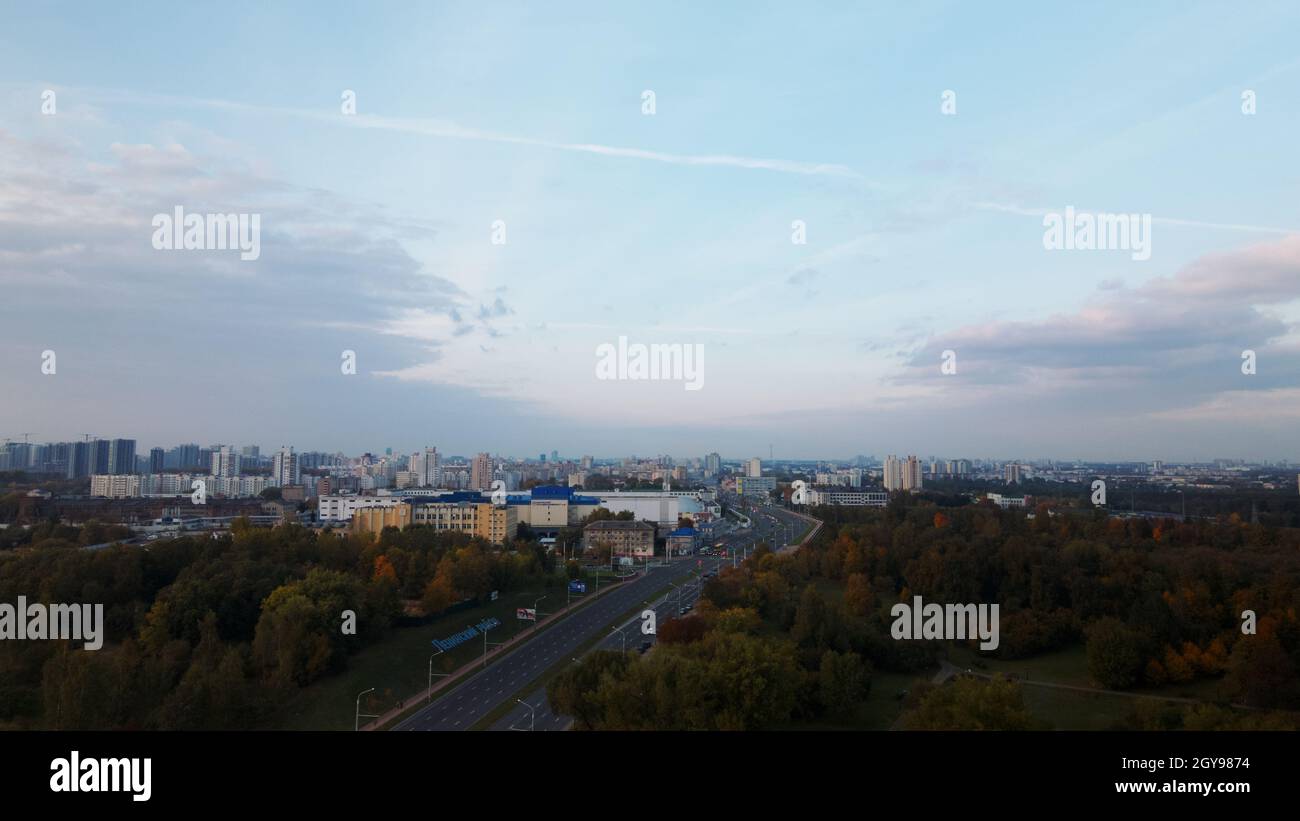 Flight over the autumn park. On the horizon there is a blue sky with ...