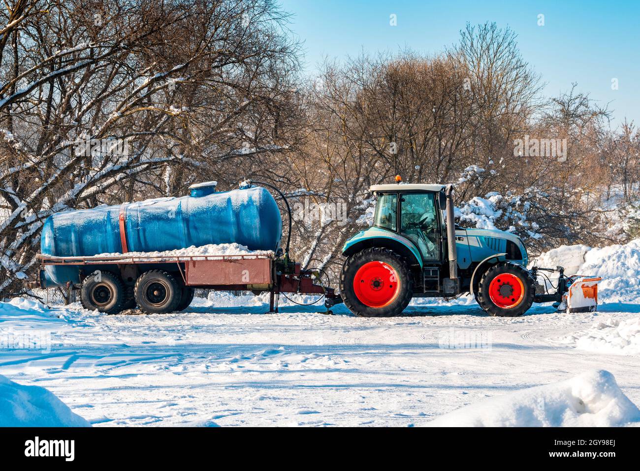 Tractor with tanker for cleaning the sewer system. Winter season. Stock Photo