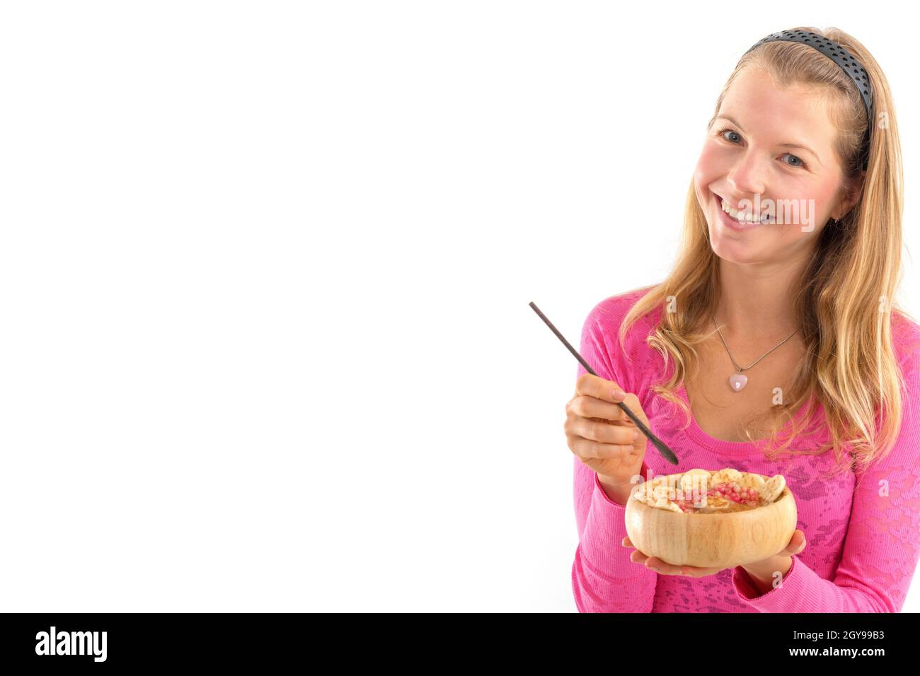 Young woman holding raw vegan healthy food. Raw food concept  bamboo bowl Stock Photo