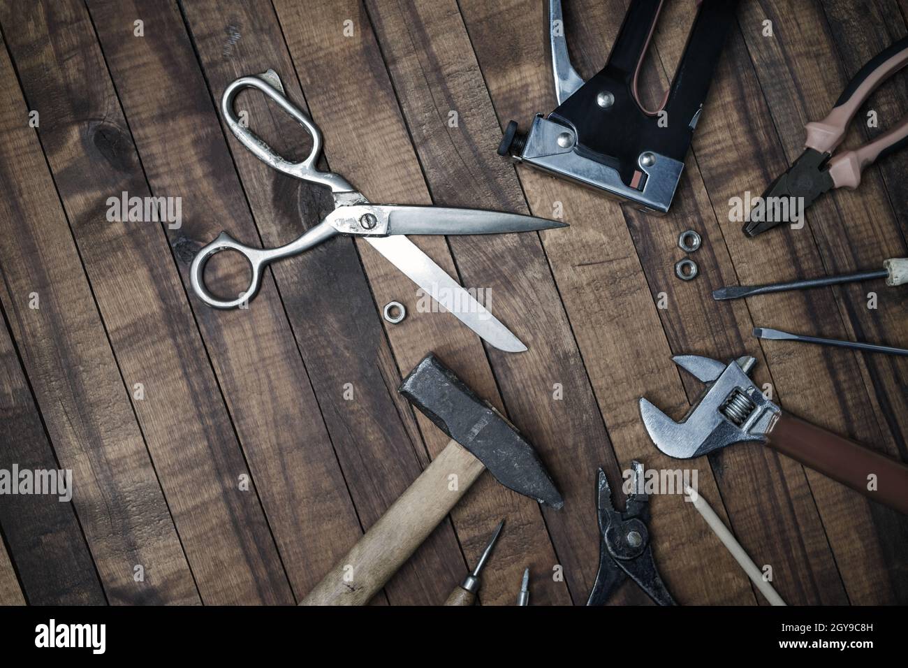 Different old tools on vintage wooden background. Flat lay. Stock Photo