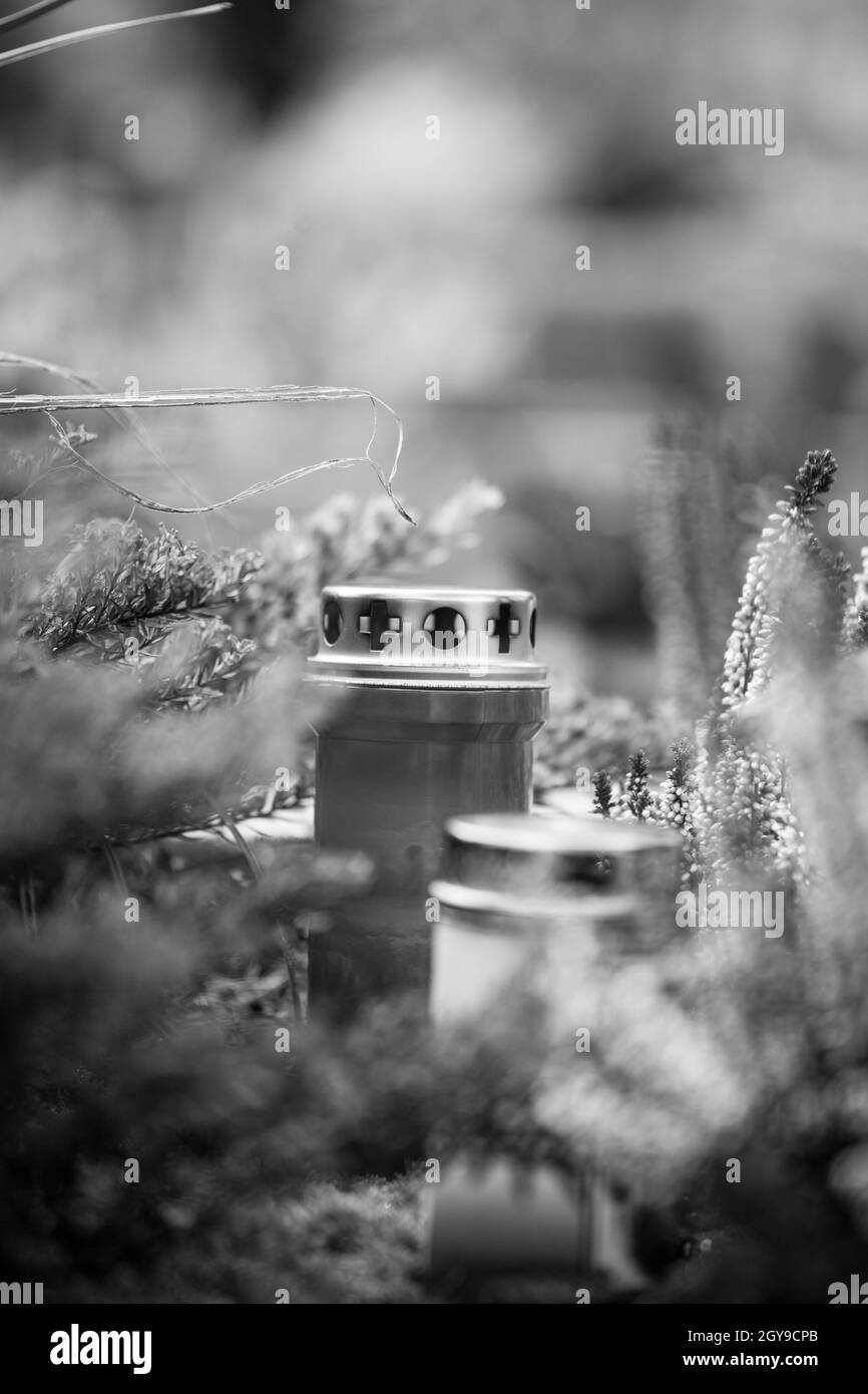 Candle on a grave at a cemetery Stock Photo