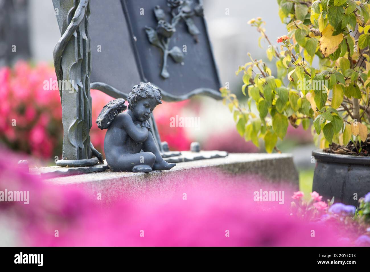 Iron Angel On A Grave At A Cemetery Stock Photo Alamy