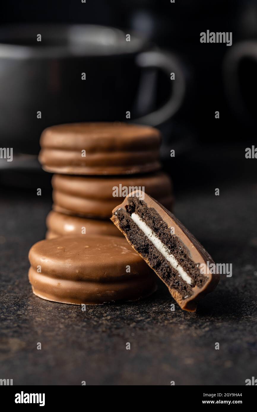 Biscuits with chocolate icing on black table. Stock Photo