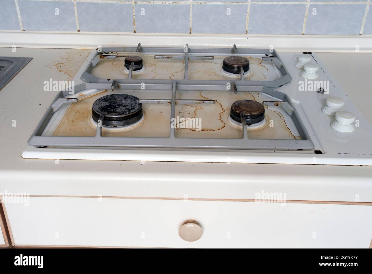 Dirty gas stove cooking oil stains on gas stove in kitchen.An Unclean