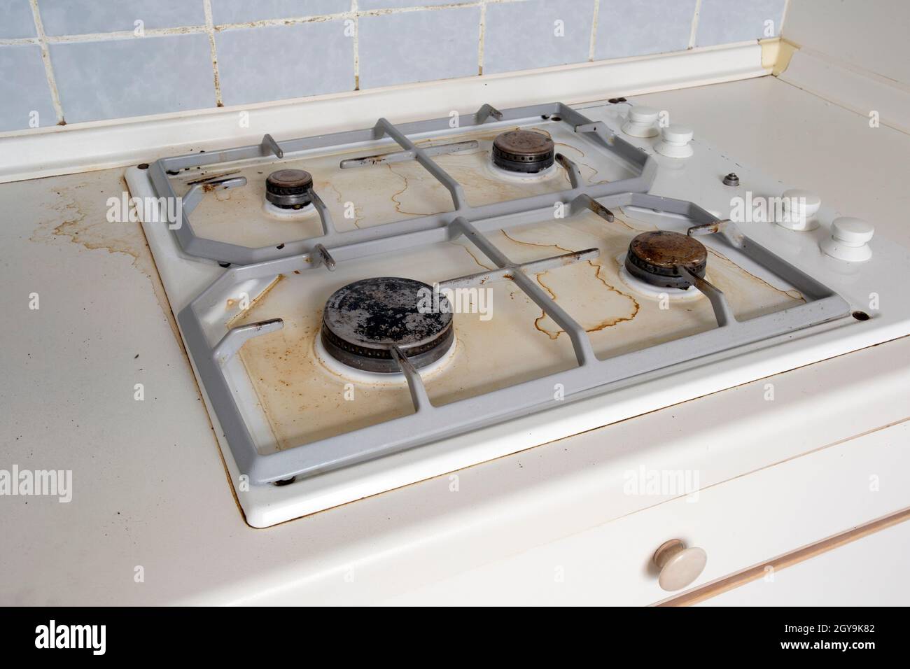 Dirty gas stove cooking oil stains on gas stove in kitchen.An Unclean