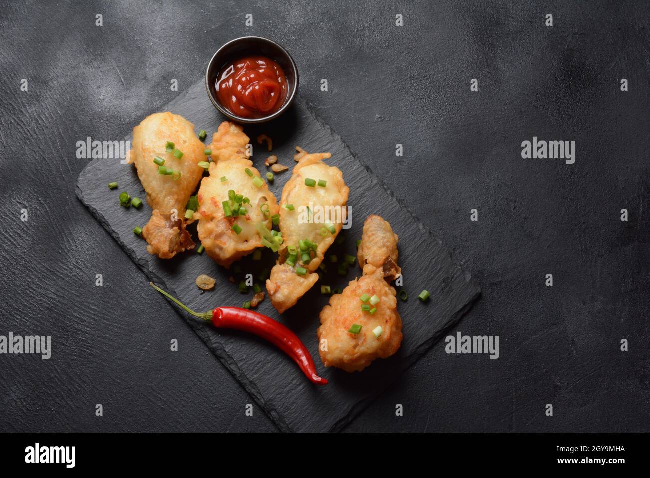 Golden crispy fried chicken drumsticks. Fried chicken pieces lightly