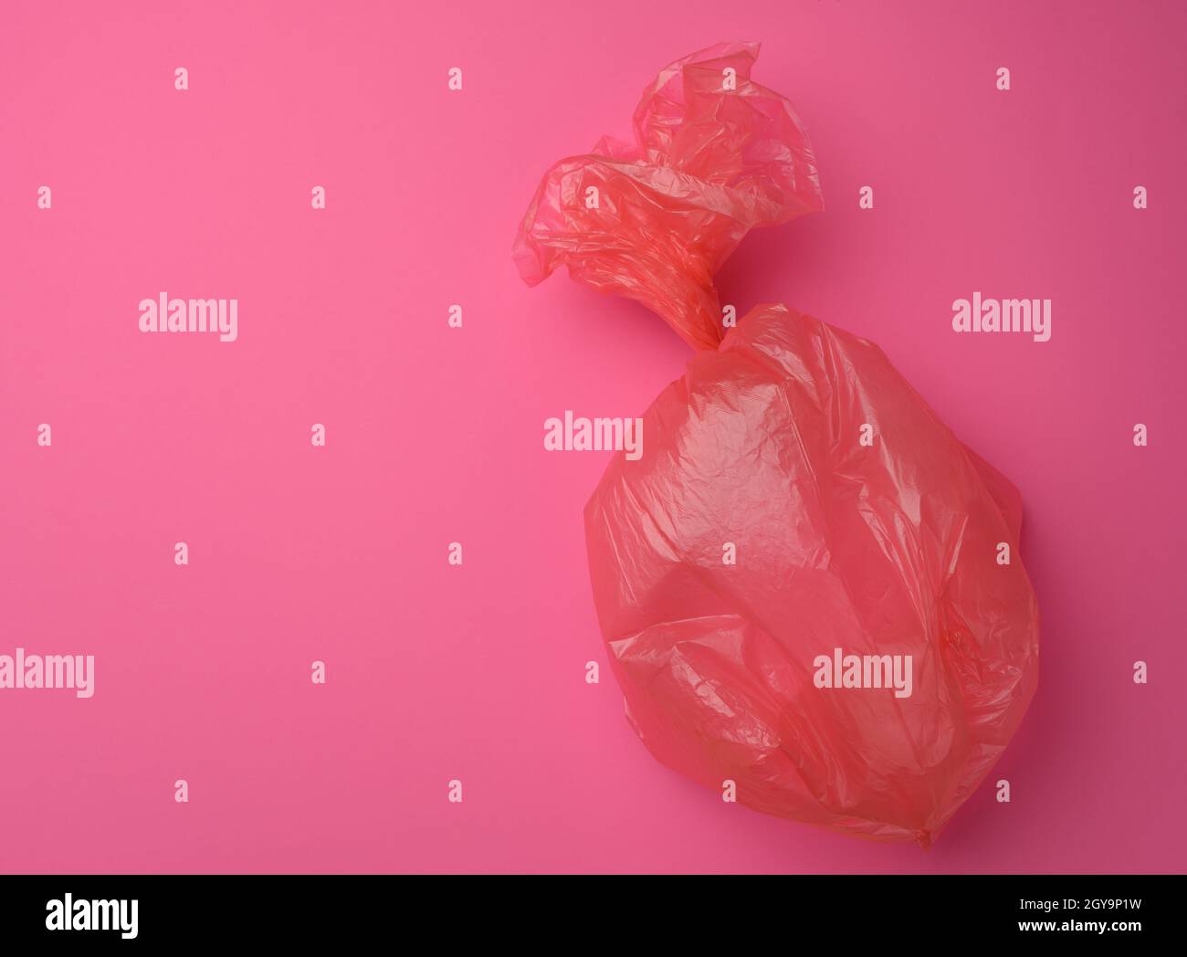 empty plastic trash bag on pink background, top view Stock Photo