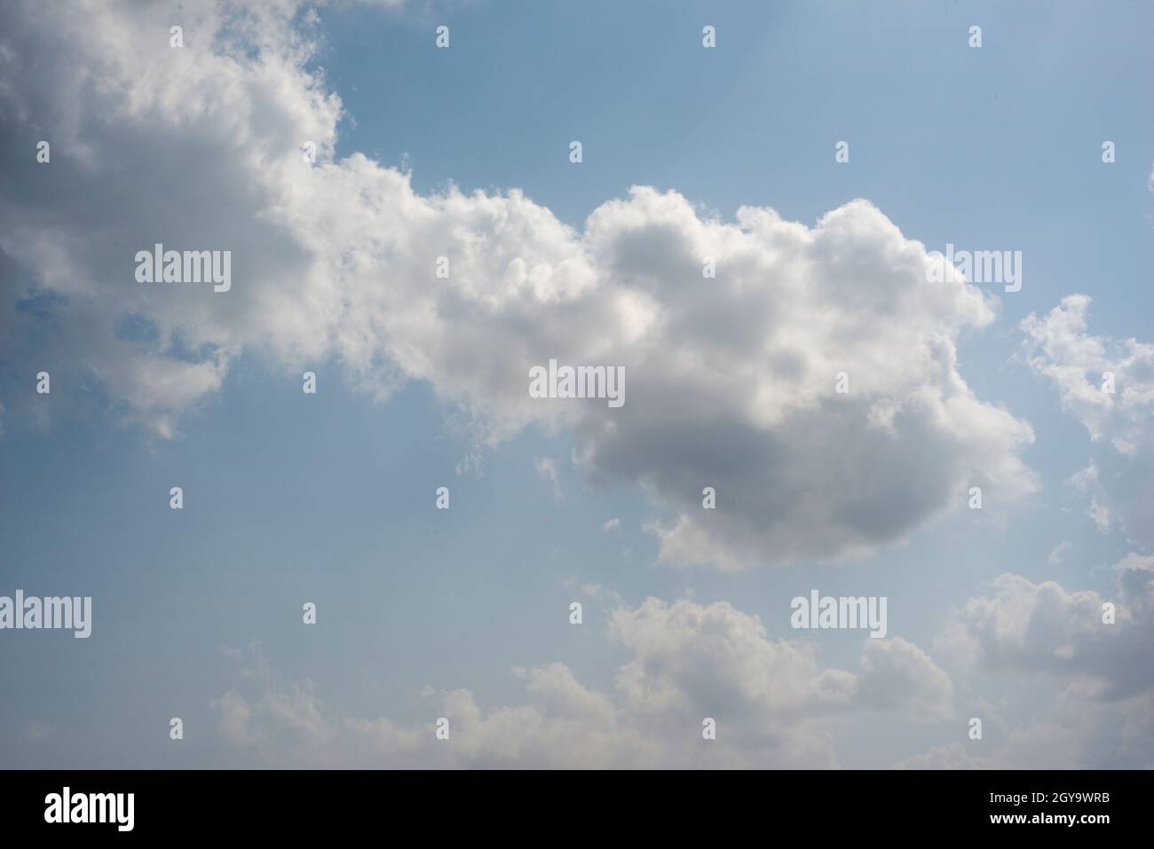 Scattered cloud clusters in a blue sky, blue sky background with white clouds, Stock Photo