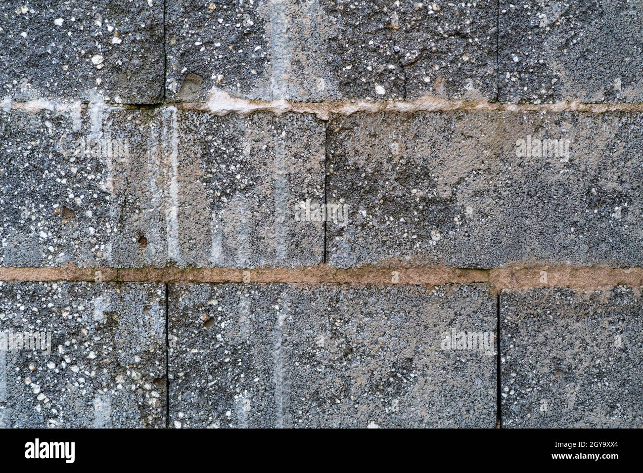 Old stone wall with structure of a garage. Background, texture