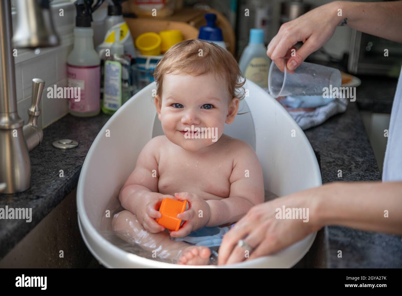 Happy baby boy taking bath in sink Stock Photo Alamy