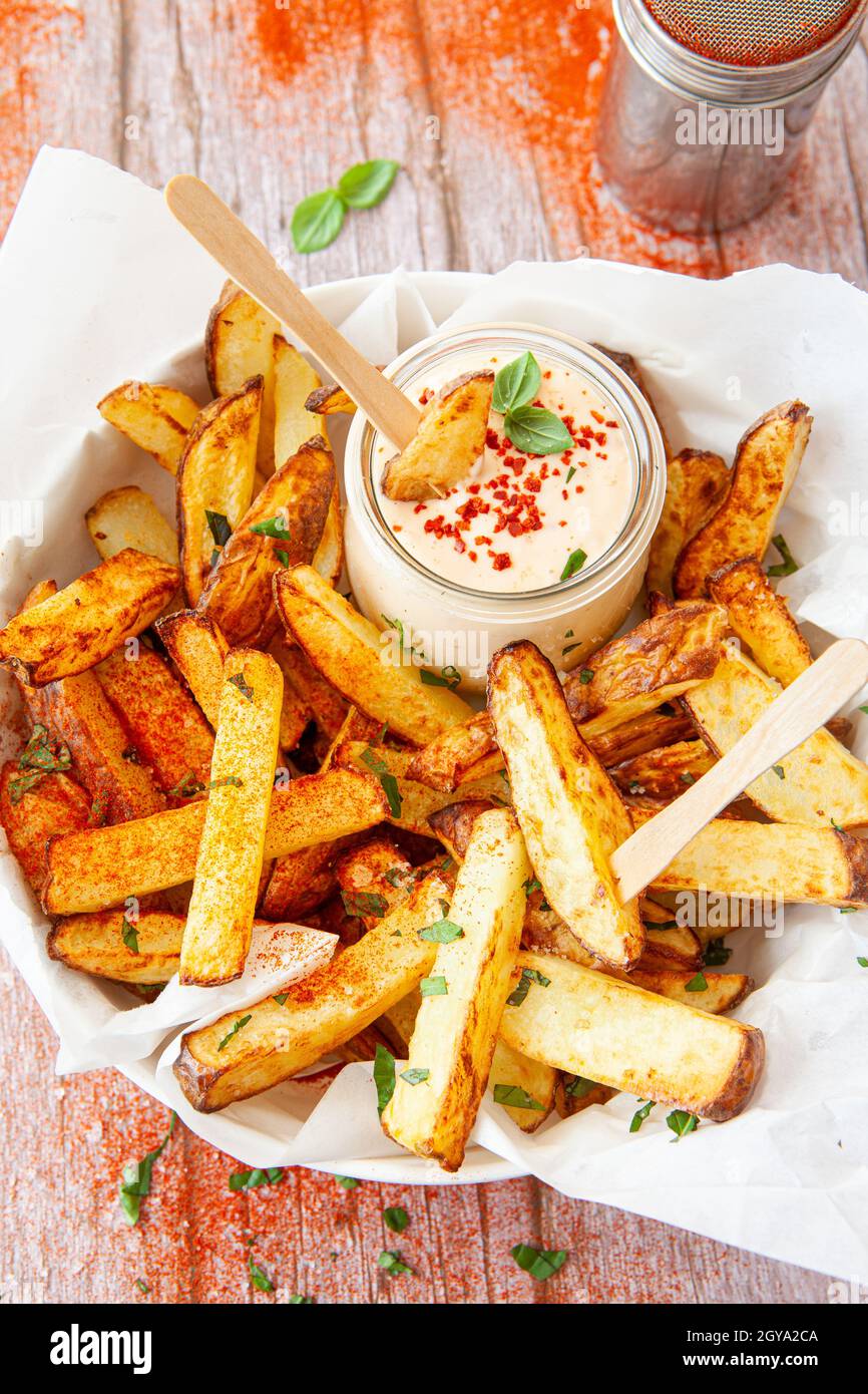 Homemade French fries, potato weddges with garlic dip Stock Photo