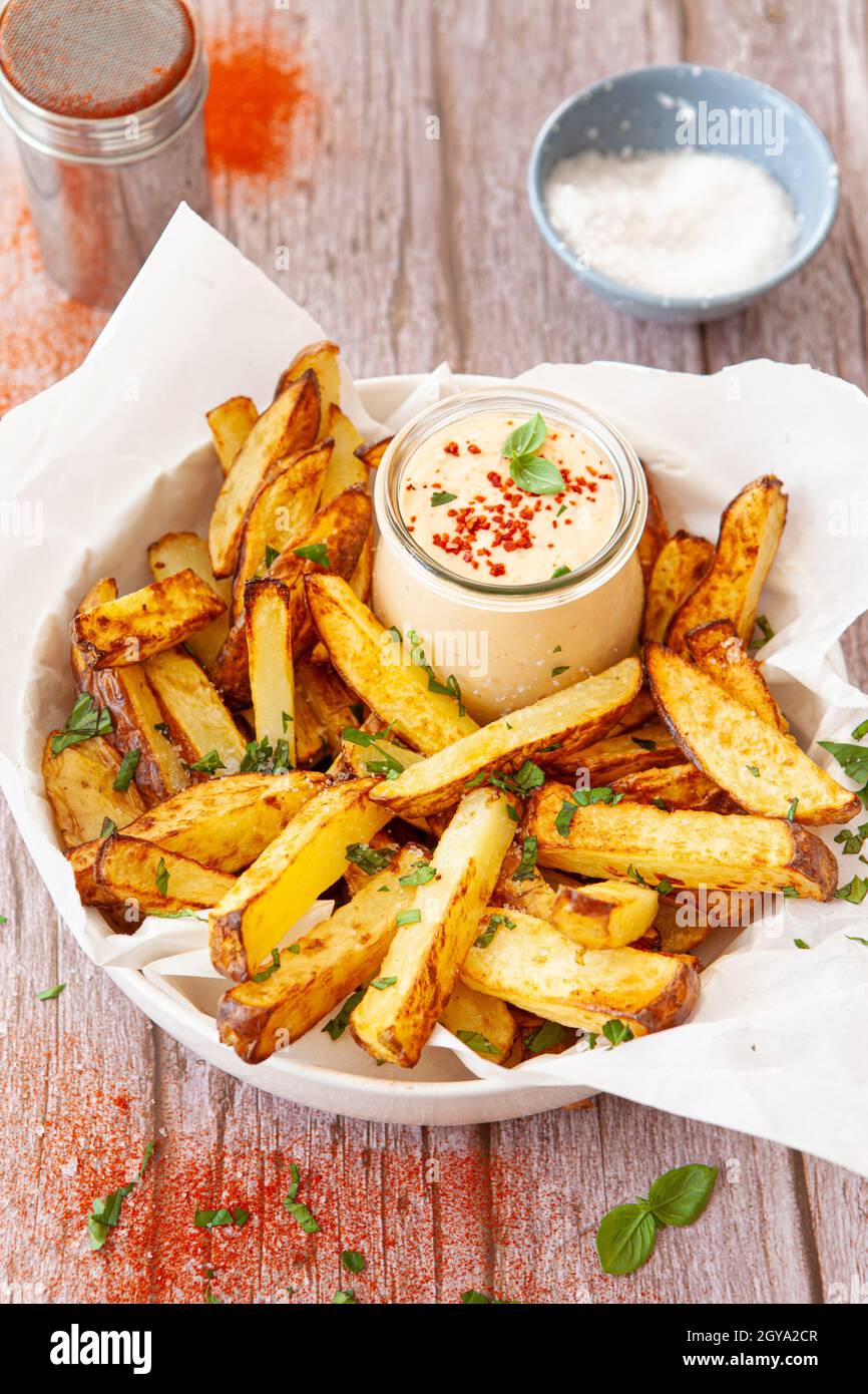 Homemade French fries, potato weddges with garlic dip Stock Photo