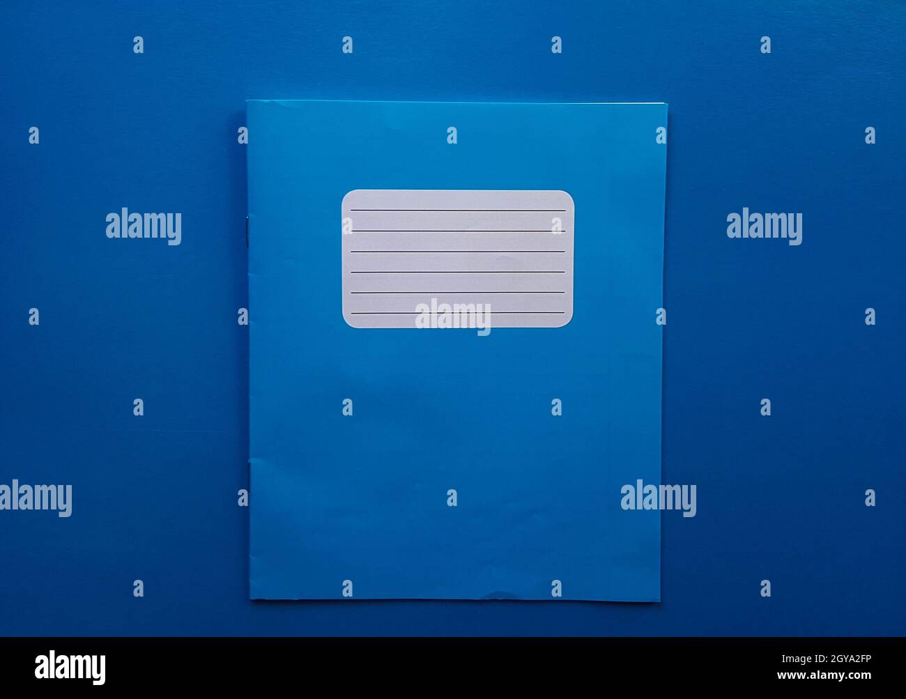 Old copybook on a blue background. School notebook, preparation for ...