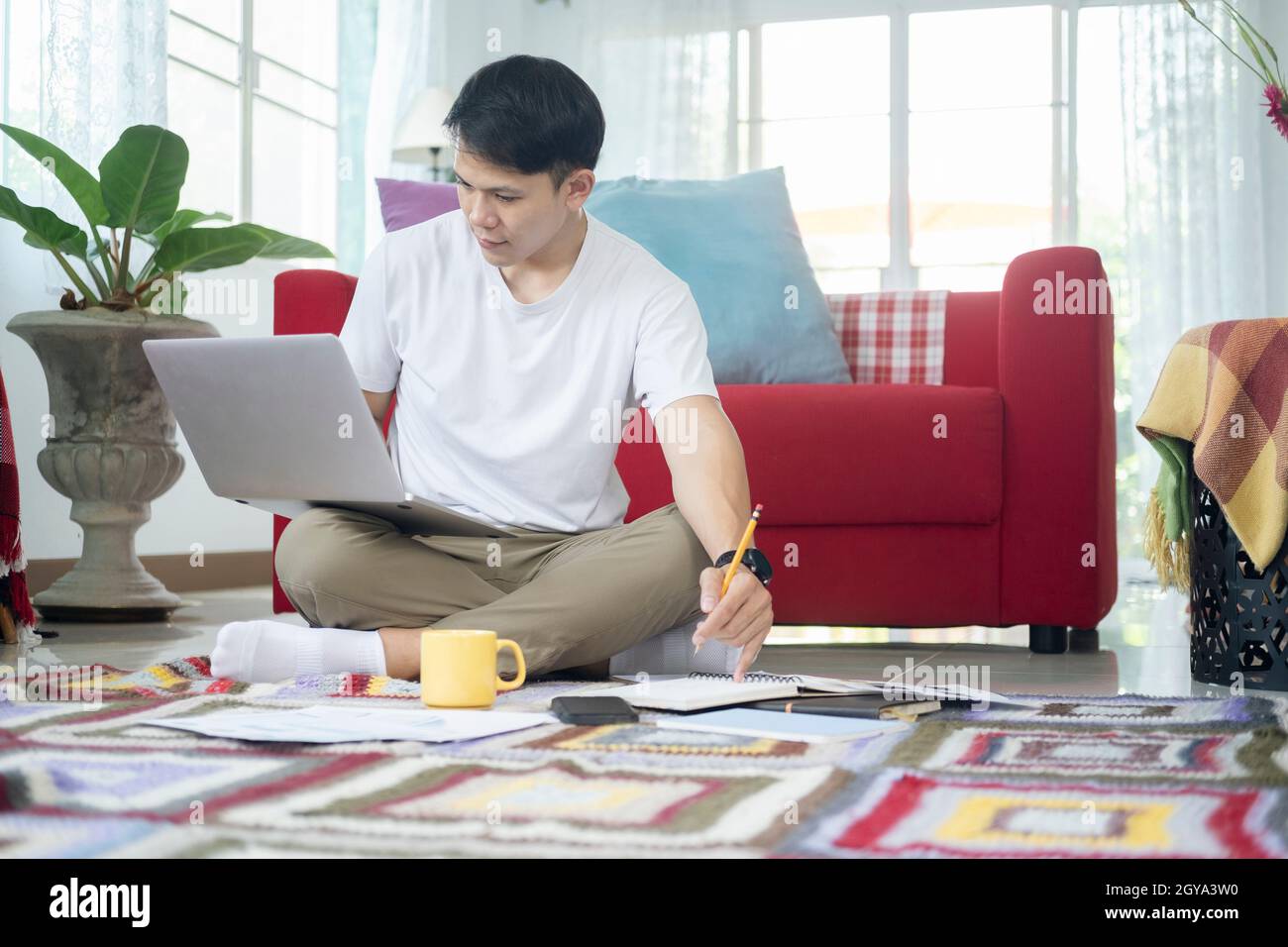 Young man online working and learning from home. Stock Photo