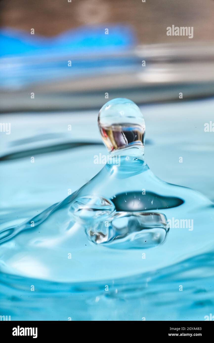 Aqua blue waterdrop with mysterious reflection Stock Photo