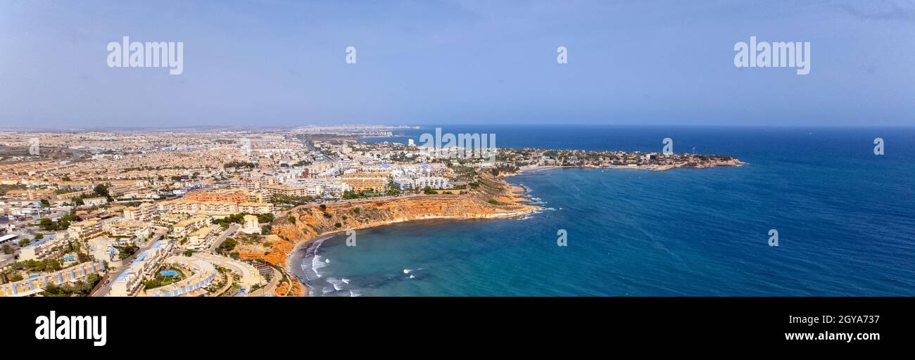 Aerial view horizontal image Dehesa de Campoamor on the Costa Blanca of Spanish tourist resort, sandy beach coastline and blue-green waters of Mediter Stock Photo