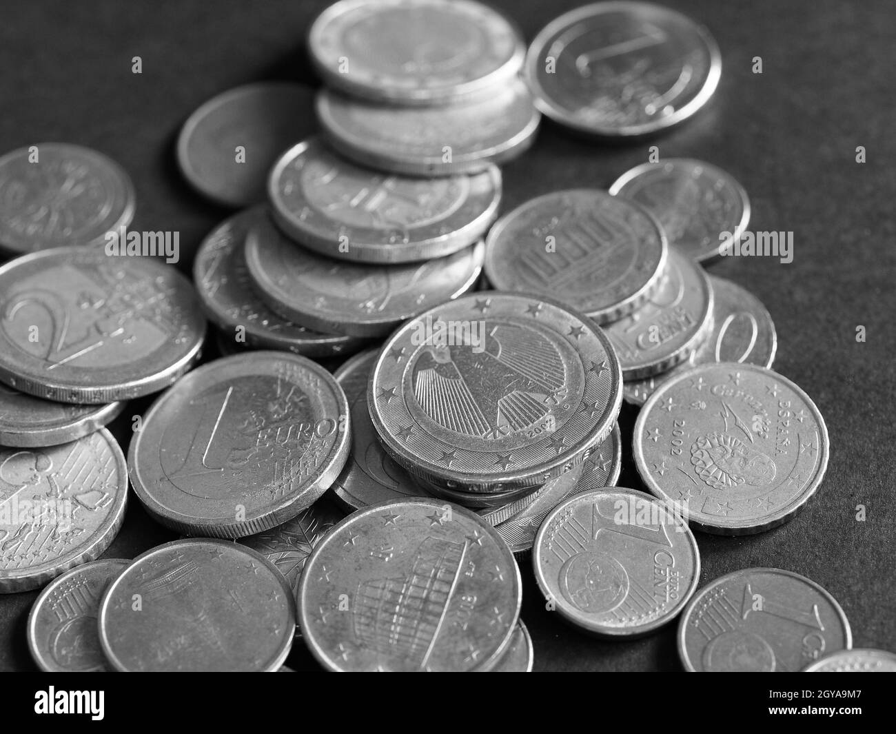 Euro coins money (EUR), currency of European Union over black background in black and white