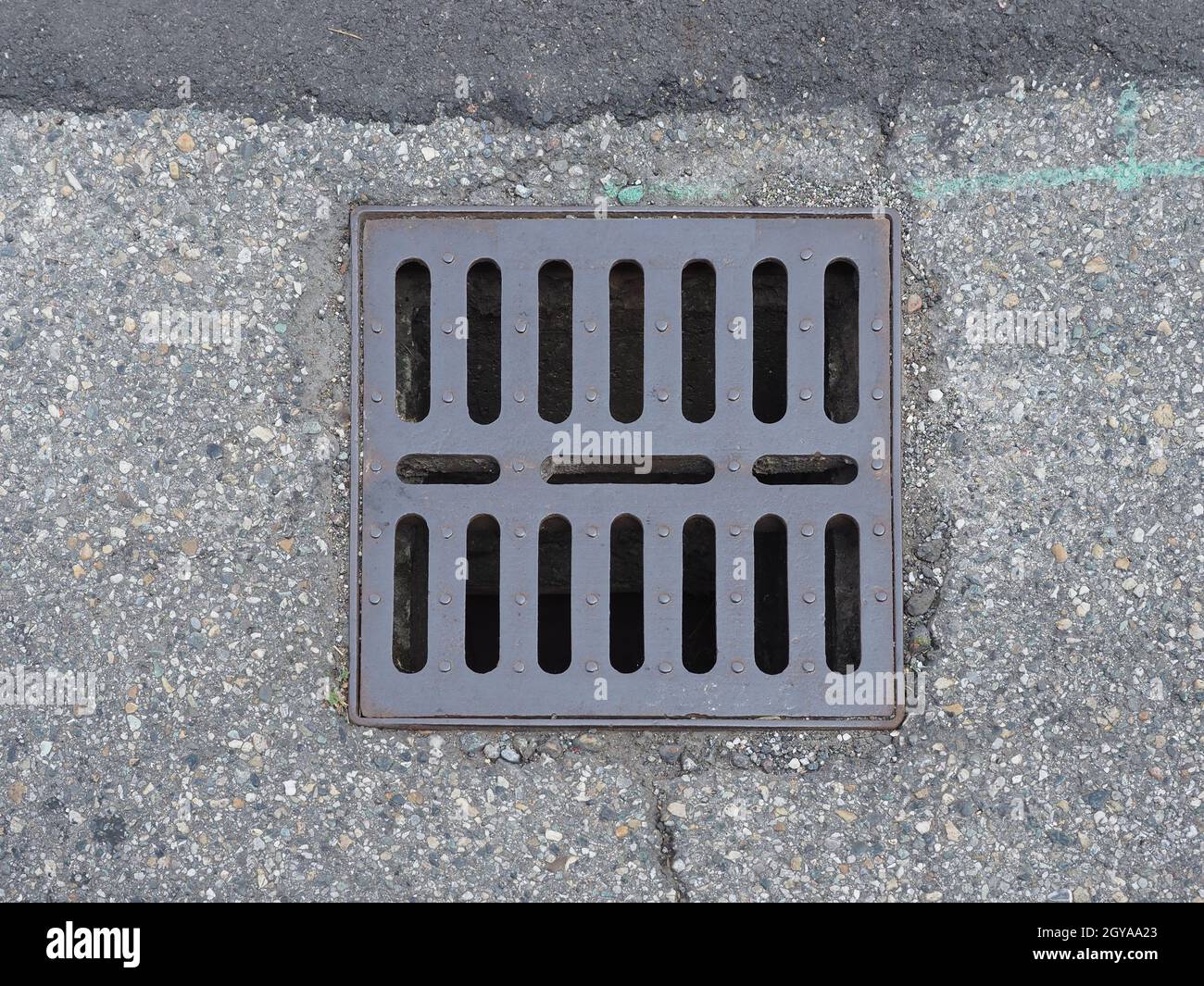 steel rain drain manhole in the street Stock Photo