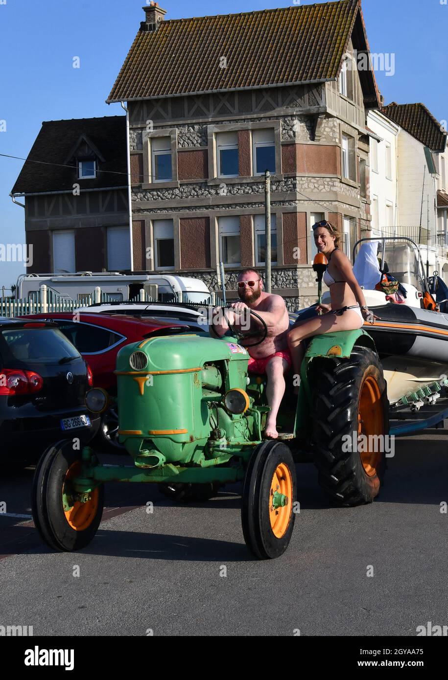 Ambleteuse on Cote d'Opale Northern France man and woman on fishermans tractor wearing bikini and shorts Stock Photo
