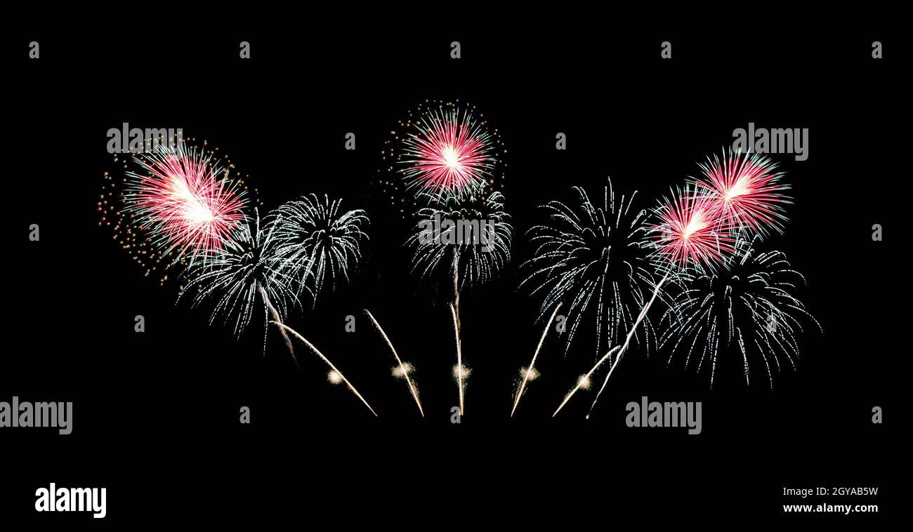 Red and green fireworks sparkling on night sky celebration Stock Photo