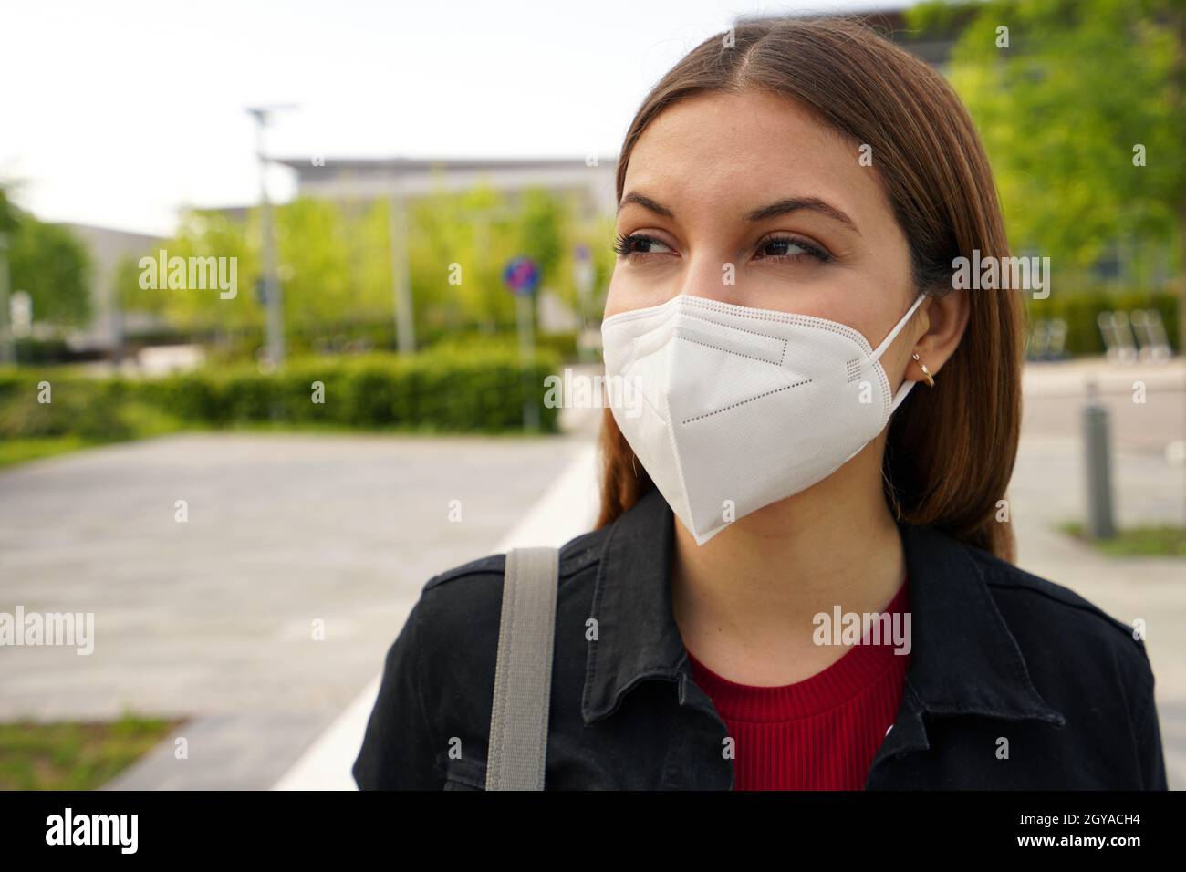 FFP2 protective mask. Close up of young woman wearing medical face mask ...